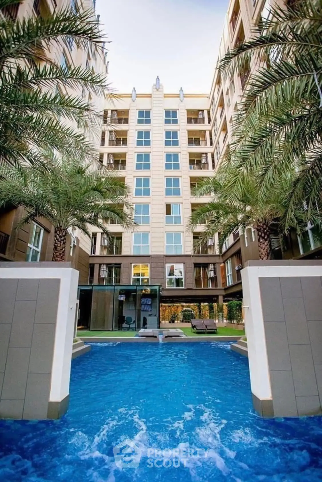 Luxurious apartment building with stunning pool and palm trees