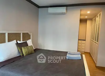 Spacious bedroom with modern decor and ample storage space