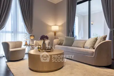 Elegant living room with modern furniture and large windows, perfect for relaxation and entertaining.