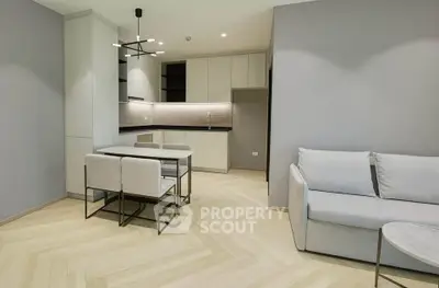 Modern open-plan living room with sleek kitchen and stylish furniture