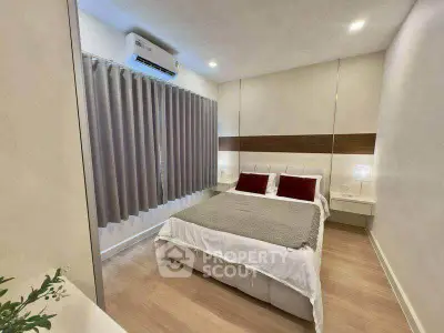 Modern bedroom with elegant decor and cozy ambiance, featuring a comfortable bed and stylish lighting.