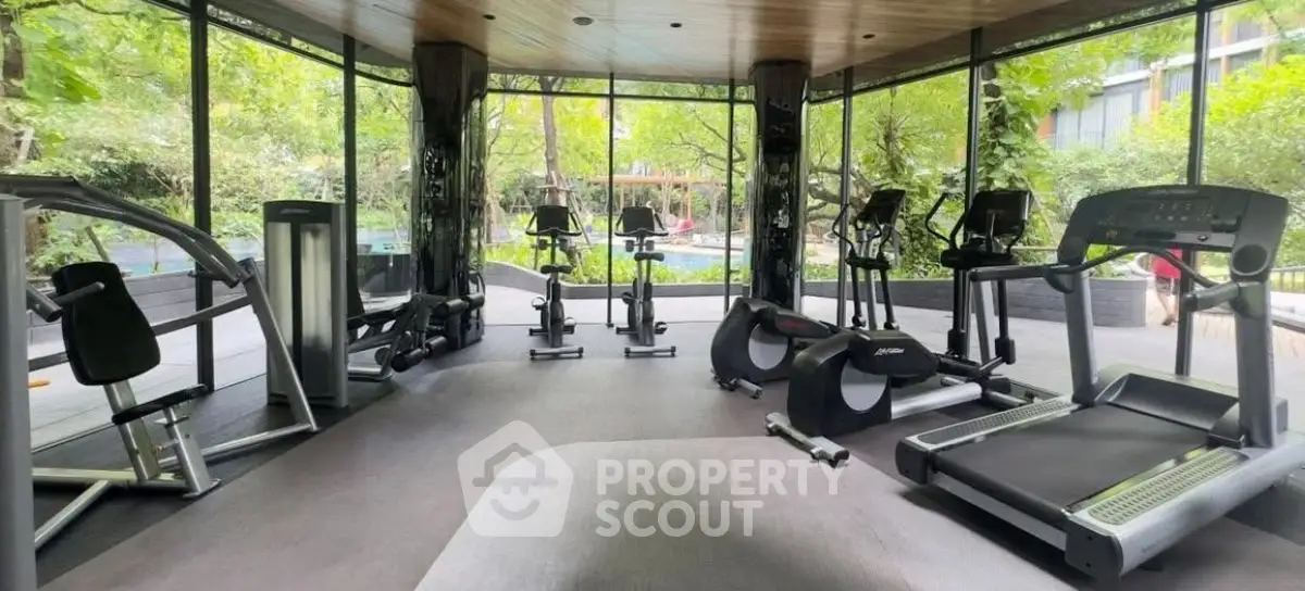 Modern gym with state-of-the-art equipment and lush garden views.