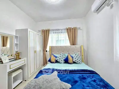 Cozy bedroom with modern decor, featuring a plush bed, stylish wardrobe, and air conditioning for comfort.