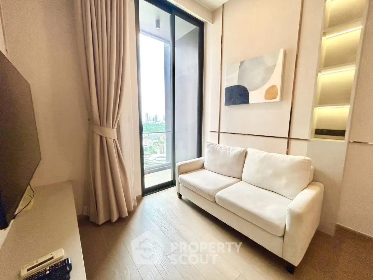 Modern living room with cozy sofa and city view from balcony