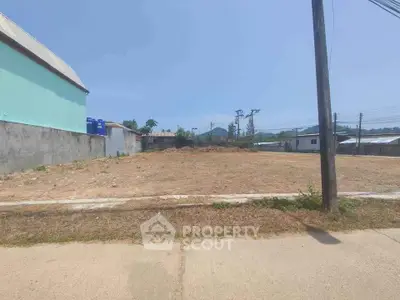 Expansive vacant lot in a developing area, perfect for constructing a dream home or investment property, with clear skies and potential for landscaping.