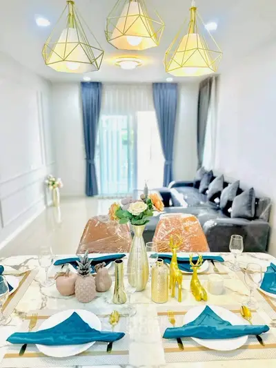 Elegant dining and living area with modern decor and stylish lighting