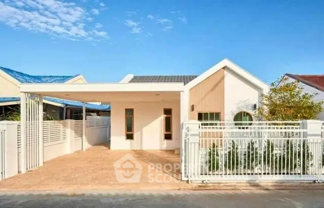 Charming single-story house with modern design and spacious driveway.