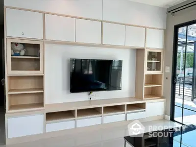 Modern living room with sleek TV unit and ample storage space