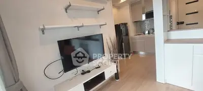 Modern living room with TV and open kitchen layout in stylish apartment