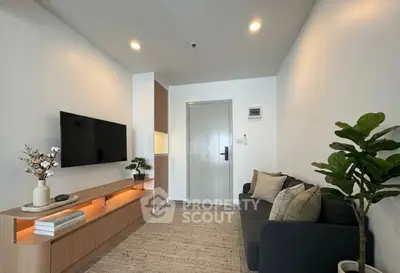 Modern living room with sleek furniture and wall-mounted TV, perfect for cozy relaxation.
