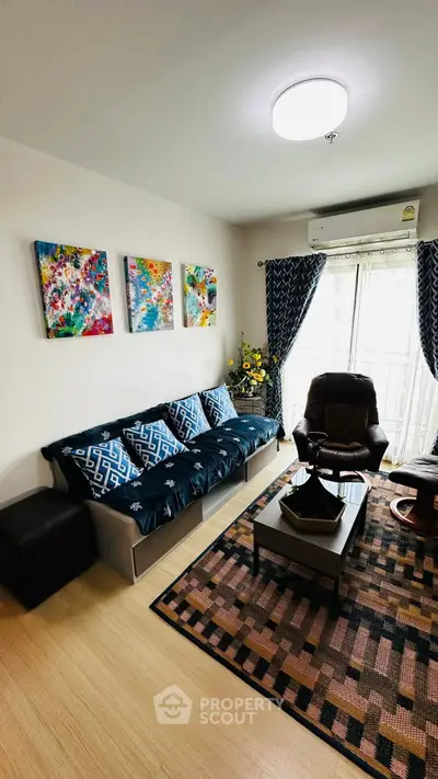 Stylish living room with modern decor and vibrant artwork, perfect for relaxation and entertaining.