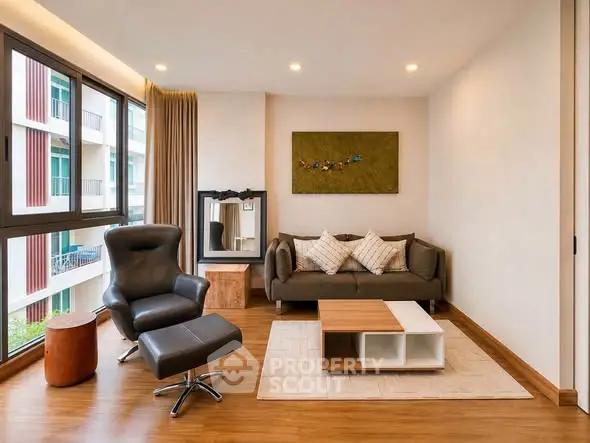 Modern living room with stylish furniture and large windows in a contemporary apartment.