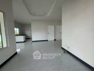 Spacious modern living room with sleek flooring and natural light