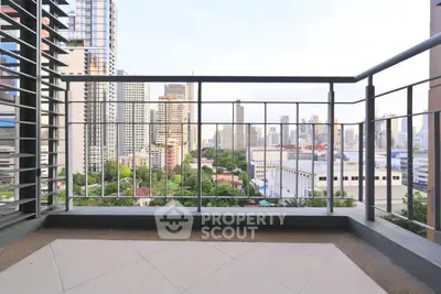 Spacious balcony with stunning city skyline view in modern high-rise apartment.