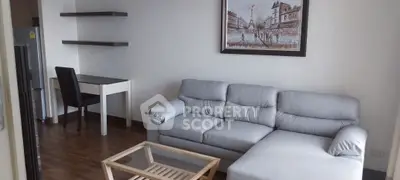 Modern living room with sleek gray sofa and elegant wooden flooring