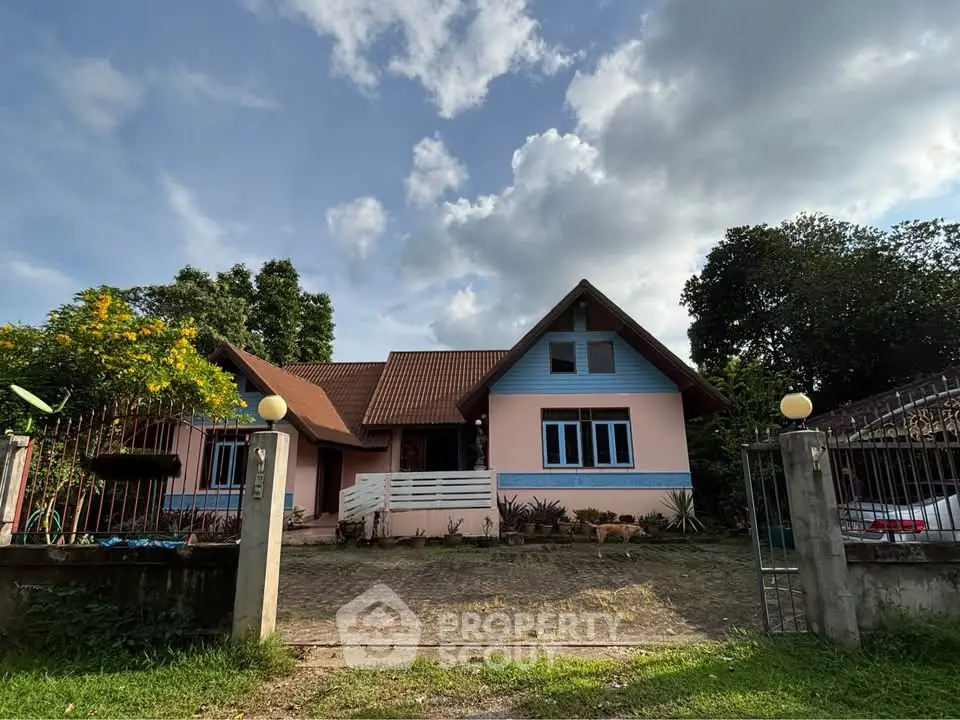 Charming suburban house with lush garden and spacious driveway under a clear blue sky.
