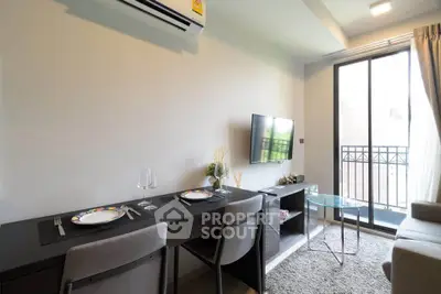 Modern living room with dining area and balcony access in a stylish apartment.