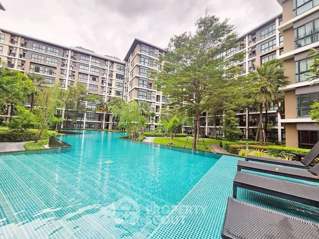 Luxurious condominium with stunning pool and lush garden view