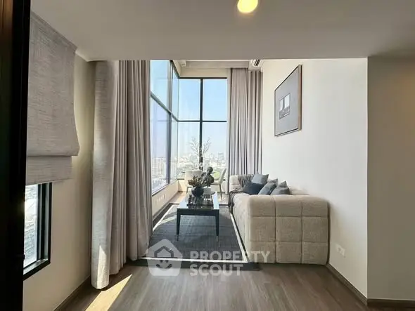 Luxurious high-rise living room with floor-to-ceiling windows and modern decor.