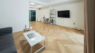 Spacious living room with modern decor and wooden flooring