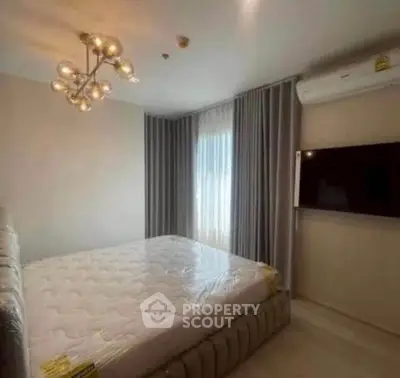 Modern bedroom with elegant lighting and wall-mounted TV