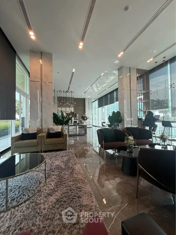Luxurious modern living room with elegant furniture and floor-to-ceiling windows offering stunning views.