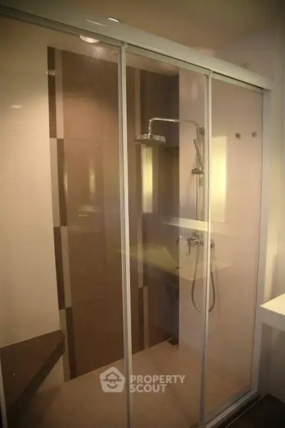Modern bathroom with glass shower enclosure and sleek fixtures