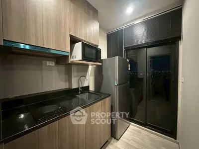Modern kitchen with sleek wooden cabinets and city view from balcony