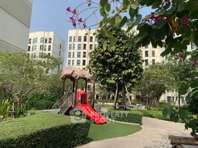 Modern apartment complex with lush garden and children's playground