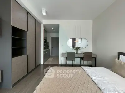 Modern bedroom with stylish decor and built-in storage in a contemporary apartment.