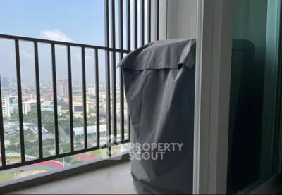 High-rise balcony with city view and covered appliance