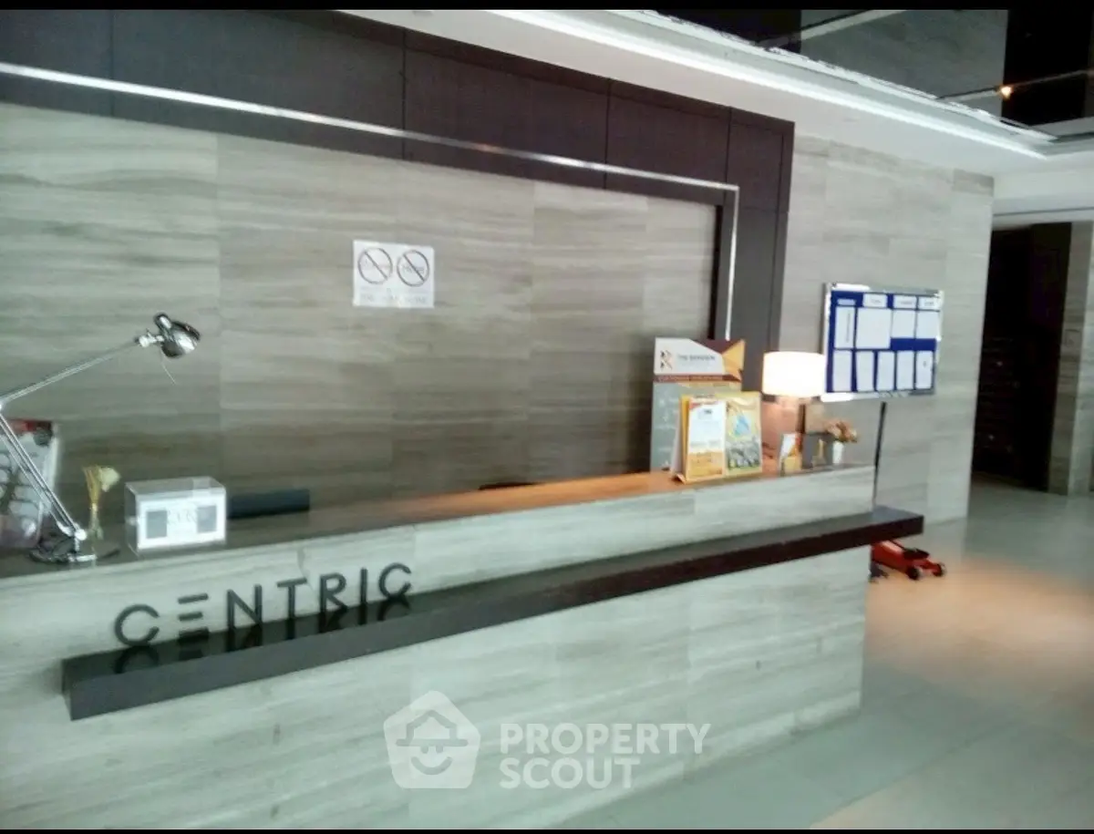 Modern building lobby with sleek reception desk and contemporary design.