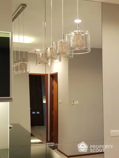 Modern interior with stylish pendant lights and mirrored wall