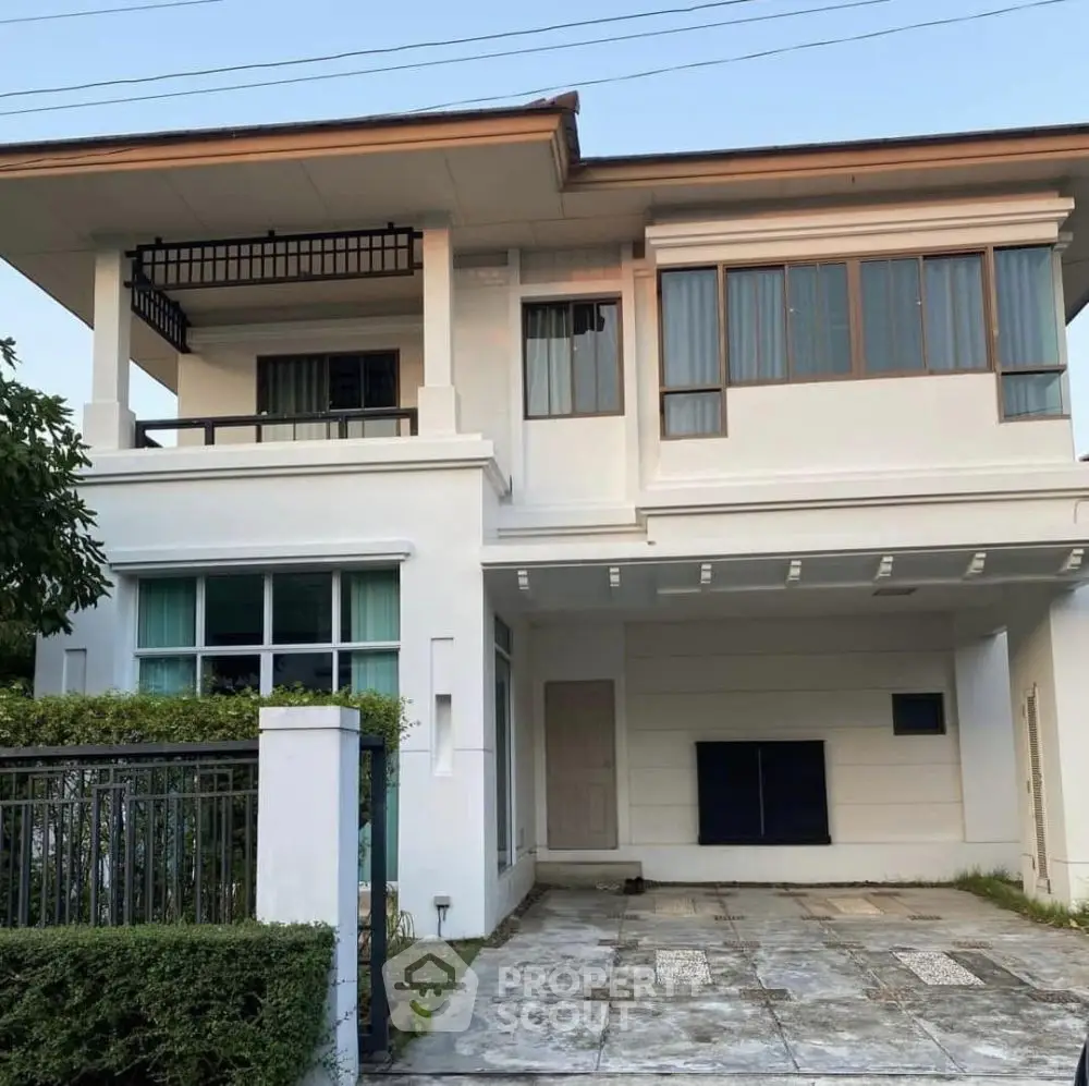 Modern two-story house with spacious driveway and large windows