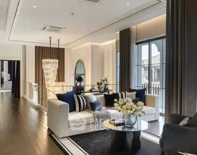 Luxurious living room with elegant decor and large windows offering natural light.