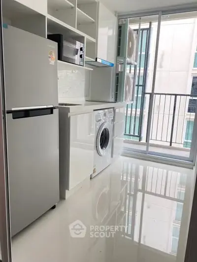 Modern kitchen with sleek appliances and balcony view