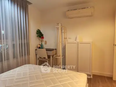 Cozy bedroom with study desk and air conditioning in modern apartment