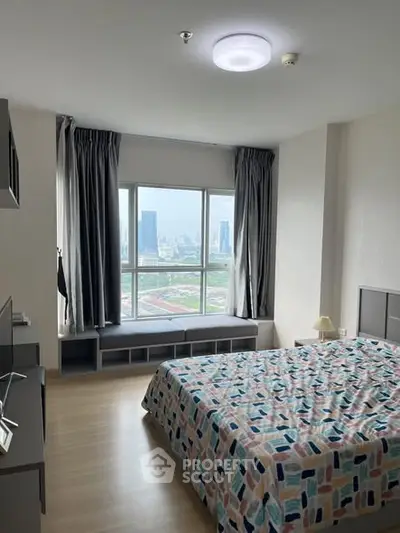 Modern bedroom with city view and stylish decor in high-rise apartment.