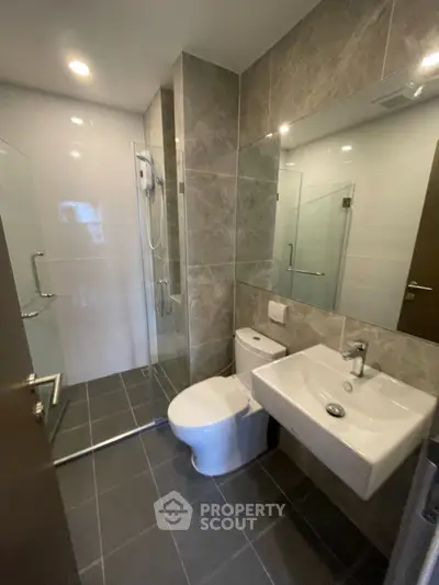 Modern bathroom with glass shower and sleek fixtures