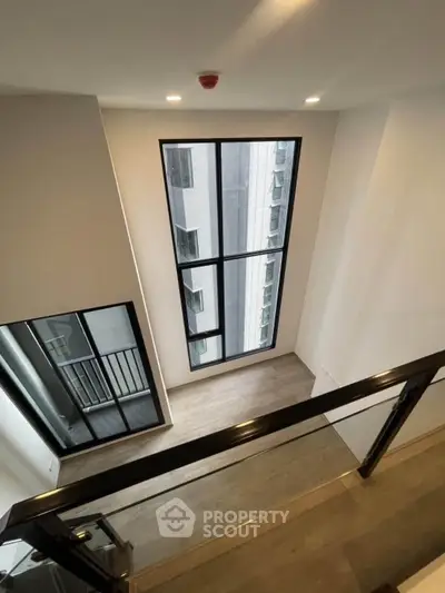 Spacious modern loft with large windows and sleek design, perfect for urban living.