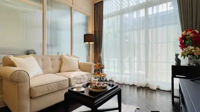 Elegant living room with cozy sofa and large window, perfect for relaxation.