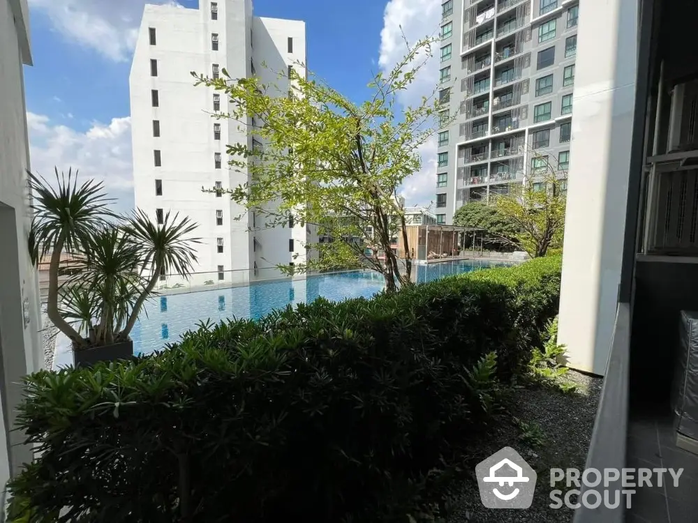 Luxurious condominium with stunning pool view and lush greenery