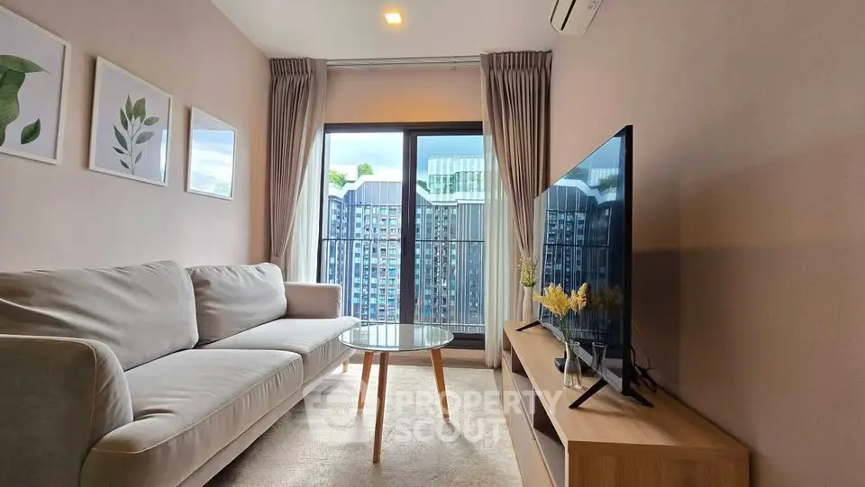 Modern living room with cozy sofa, large TV, and city view from balcony.