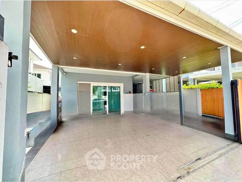 Spacious covered parking area with modern design and ample lighting.
