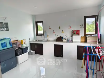 Spacious laundry room with modern amenities and ample storage space.