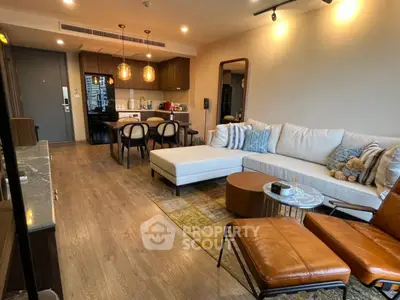 Modern living room with open layout, stylish furniture, and warm lighting in a contemporary apartment.