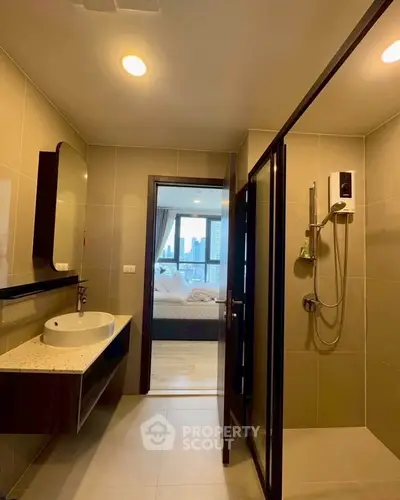 Modern bathroom with sleek design and city view from adjacent bedroom