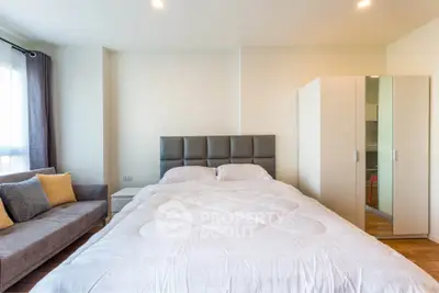 Spacious bedroom with modern decor and ample natural light