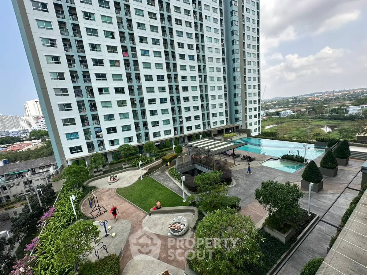 Luxurious high-rise building with pool and landscaped garden offering stunning city views.