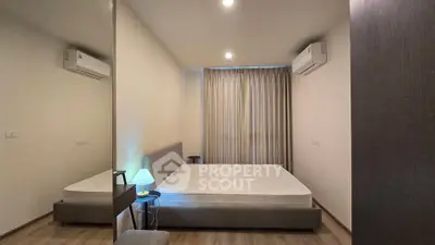 Modern bedroom with minimalist design, featuring a comfortable bed, air conditioning, and soft lighting.